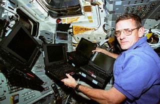 McArthur in flight deck with 4 laptop computers